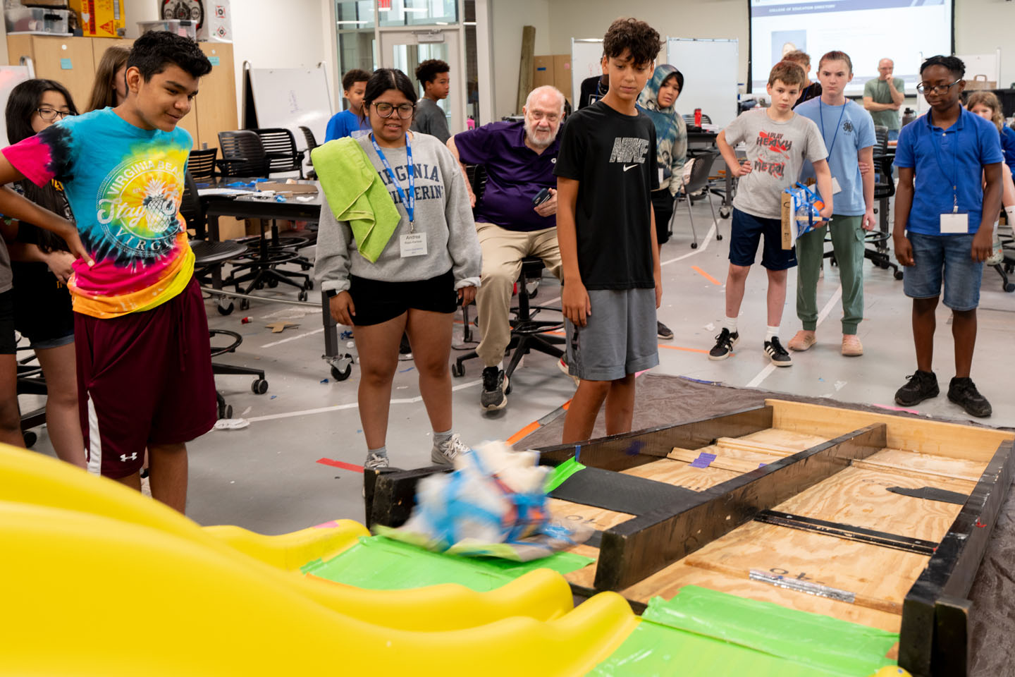 From left, Anthony Castillo (in the tie-dyed shirt), Andrea Rojas Ramirez (a Society of Women Engineers member), Evan Fisher, Harlem Stanford (peeking out from hoodie), William Beaver, Celeste Ide, and T.J. (Tavarus) Gray await the results.