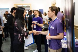 A student shakes hands with a recruiter at the engineering career fair