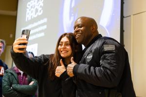 Leland Melvin takes a selfie with a student