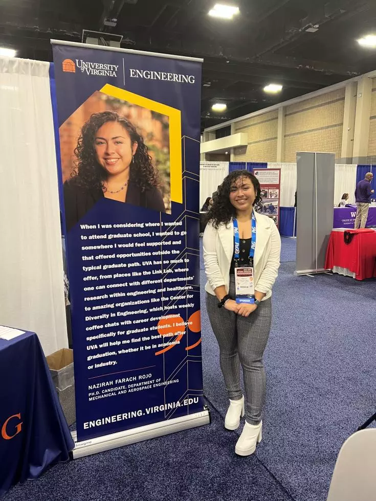 Student with recruitment banner at event