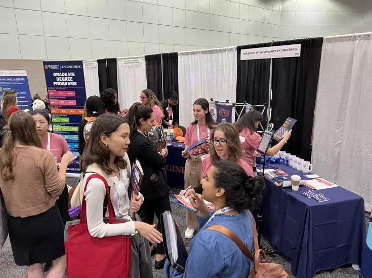 Students at the UVA Engineering table at a recruitment event