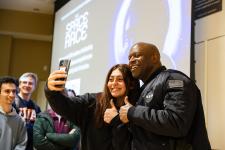 Leland Melvin poses for a photo with a student