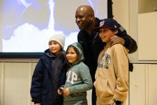 Leland Melvin takes a photo with young community members