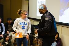 A student speaks to Leland Melvin