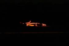 CAVCAR is pictured in motion, outfitted with orange LED lights to make it visible in the pitch black.