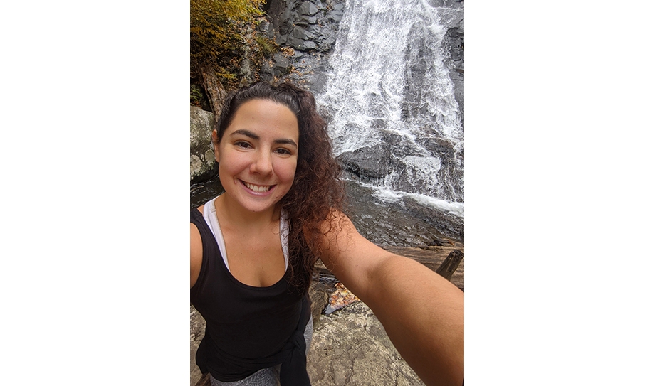 Ashley Conley standing in front of a waterfall