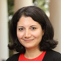 Woman smiling in front of blurred columns