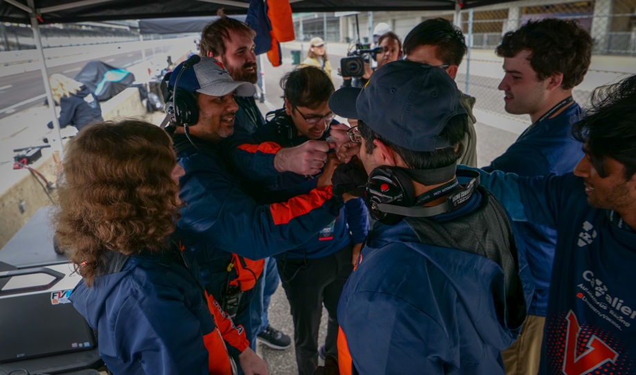 the UVA team in their pit at the track