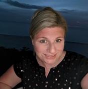 woman at night time smiling outside