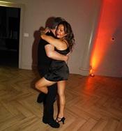 woman in black dress salsa dancing with man in black outfit