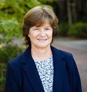 image of woman in navy blue jacket smiling outside