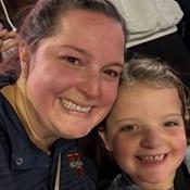 Woman and child smiling at a sporting event