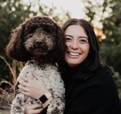 Image of woman in dark sweater holding dog