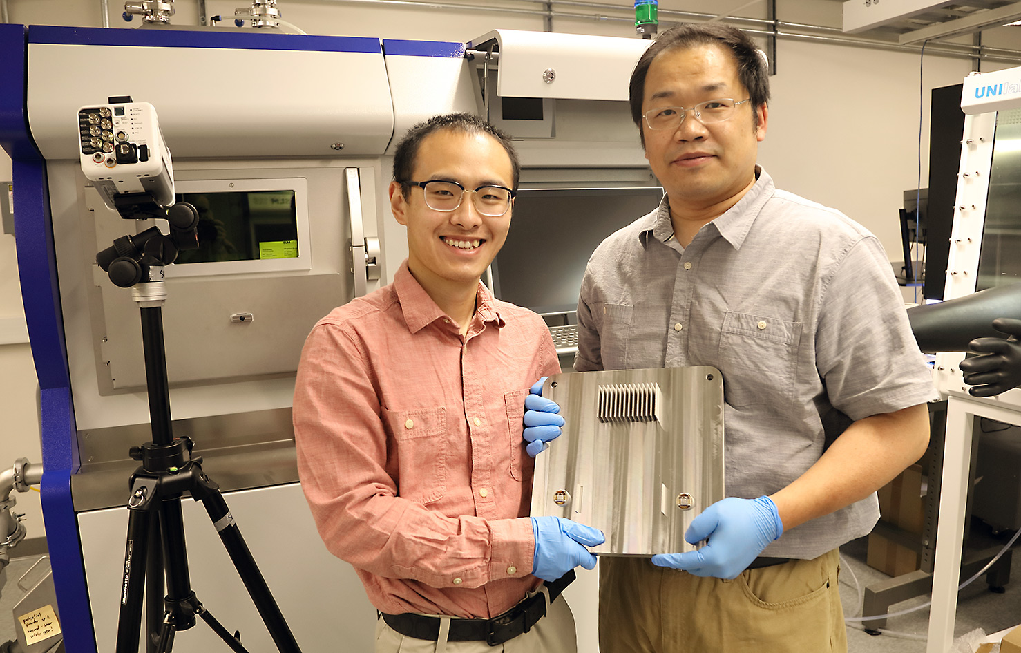 UVA materials science and engineering postdoctoral fellow Zhongshu Ren, left, and Tao Sun display the results of their research. Ren is the first author of the Science journal article. 