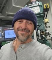 Image of Tanner in lab wearing blue cap