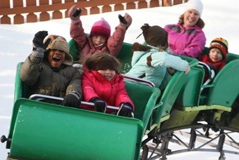 Rippey, pictured as a child, front left, enjoys a small rollercoaster.