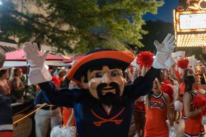 UVA mascot Cavman with cheerleaders and fans on the Charlottesville downtown mall