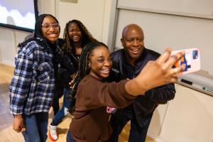 Leland Melvin poses for a selfie with students