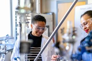 Graduate student in chemical engineering lab with professpr