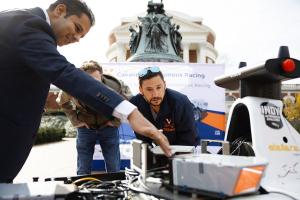 Associate professor Madhur Behl explains how the Cavalier autonomous racing car works. Photo by Tom Daly for UVA Engineering