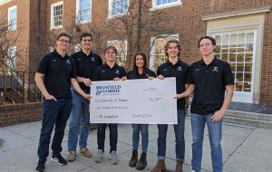 six students with their prize check from the competition