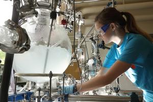 A student works on the chemical engineering distillation column
