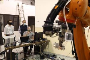 Robotic arm and researchers at the Center for Applied Biomechanics