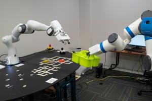 Robotic arms transfer items