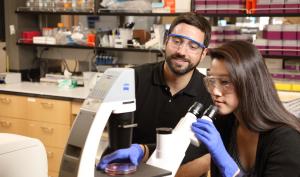 Chemical engineering professor with graduate student at a microscope