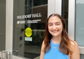 Morgan Small stands at the door of Wilsdorf Hall