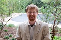 Man wearing beige jacket standing outside