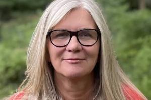 image of woman in red sweater with glasses