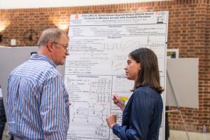 Melika Morsali explains her research to a UVERS attendee.
