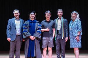 The Dean and the Associate Dean for Graduate Education and Post-Doctoral Affairs pose with three Outstanding Student Awardees