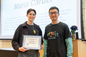 image of woman receiving an award certificate from a male professor