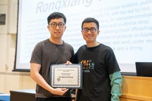 image of man receiving award certificate from a male professor