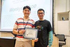 image of man receiving an award certificate from a male professor