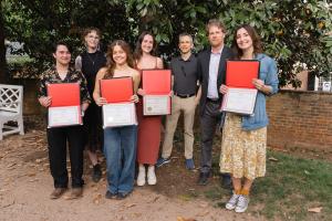 Students honored for their Science, Technology and Society research stand with their professors.