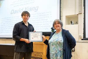 image of man receiving an award certificate from a female professor