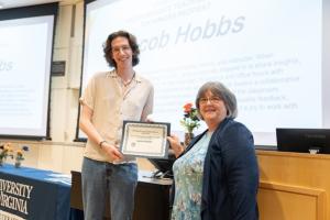 image of man receiving an award certificate from a female professor