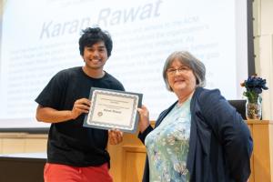 image of man receiving an award certificate from a female professor
