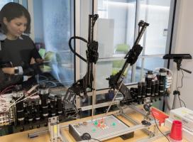 professor looking at robotic surgery instrument