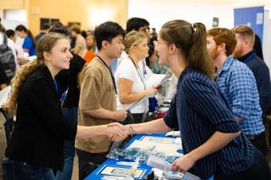 student shaking hands with employer at career fair