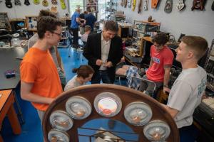 Gavin Garner and a group of students in the Mechatronics Lab looking at a project