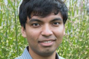 man in blue collared shirt with short brown hair