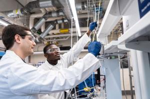 University of Virginia assistant professor of chemical engineering Jason Bates and Ph.D. student Isaac Boateng discuss the configuration of gases to be used in catalysis testing..