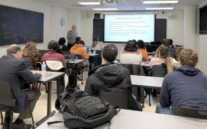 Students in a classroom listening to a lecturer