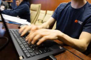 Close up shot of blurred hands moving on a computer keyboard