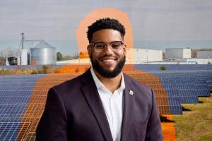 Composite image of a young man against a backdrop of agricultural buildings and a large solar panel array.
