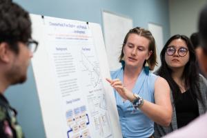 a student presents a poster.